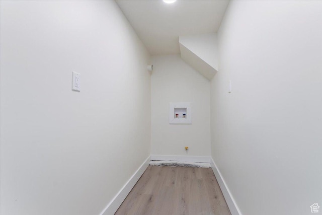 washroom featuring gas dryer hookup, washer hookup, light wood-type flooring, and baseboards