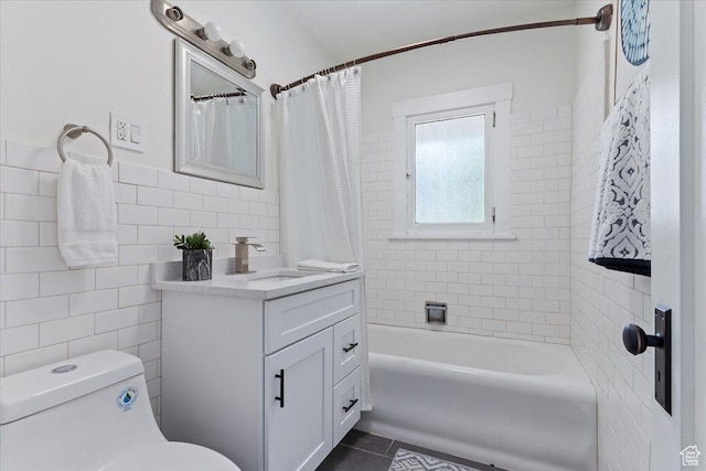 full bath with tile walls, tile patterned flooring, toilet, vanity, and shower / bathtub combination with curtain