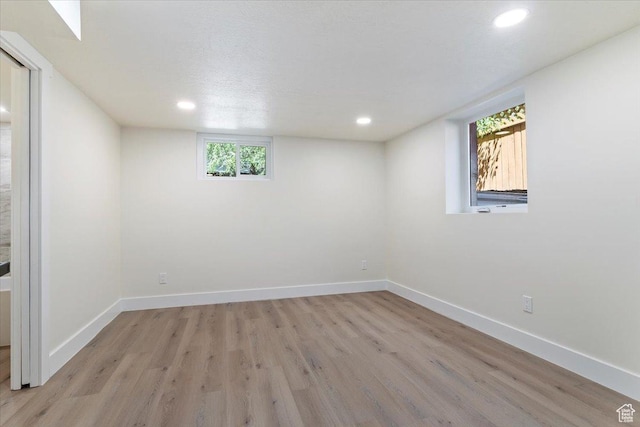 unfurnished room featuring light wood-style flooring, recessed lighting, and baseboards