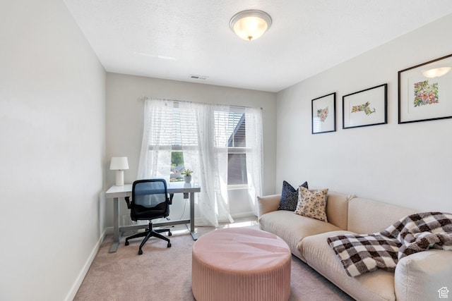 office featuring light carpet and baseboards