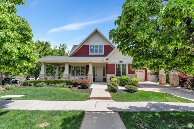 craftsman inspired home featuring board and batten siding, stone siding, covered porch, concrete driveway, and a front yard
