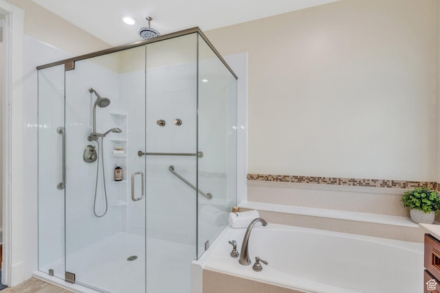 bathroom with a shower stall and a bath