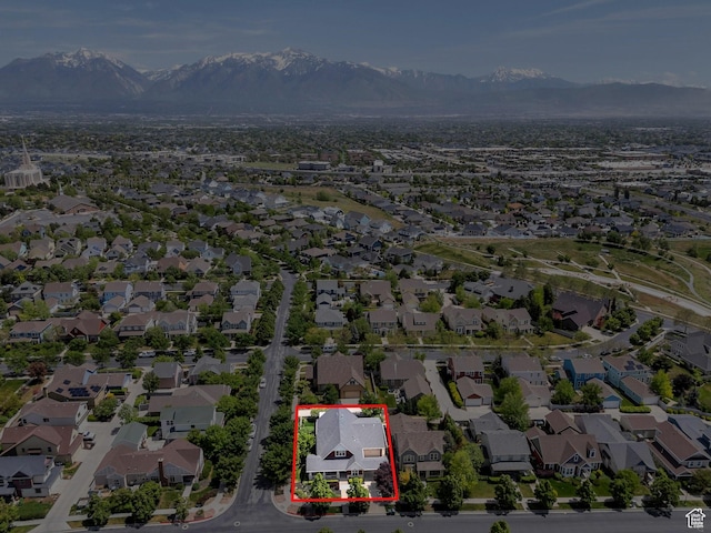 aerial view of residential area featuring a mountain backdrop and property parcel outlined