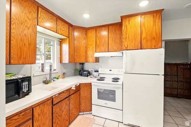 1317 S 400 E, Trenton, UT 84338 - kitchen with white appliances, under cabinet range hood, a sink, light tile patterned floors, and light countertops