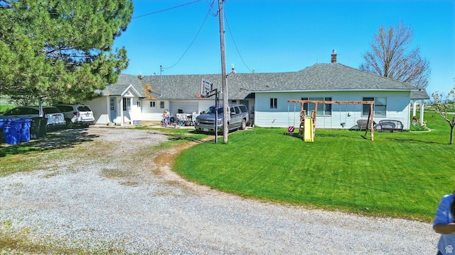 1317 S 400 E, Trenton, UT 84338 - view of front of property with a front yard, dirt driveway, and a shingled roof