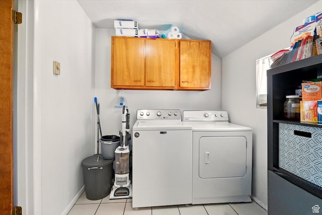 1317 S 400 E, Trenton, UT 84338 - clothes washing area featuring washing machine and clothes dryer, cabinet space, light tile patterned floors, and baseboards