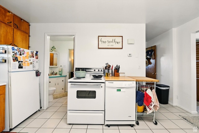 1317 S 400 E, Trenton, UT 84338 - kitchen with white appliances, brown cabinets, light countertops, and light tile patterned floors