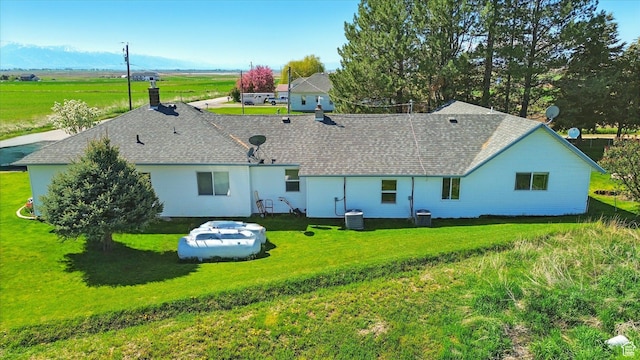 1317 S 400 E, Trenton, UT 84338 - back of property featuring a yard, a shingled roof, and central AC