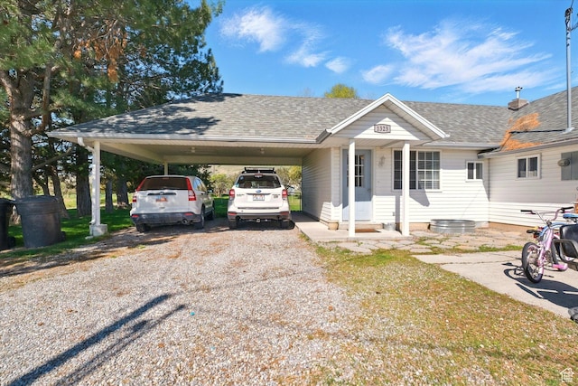 1317 S 400 E, Trenton, UT 84338 - view of front of home with a carport, gravel driveway, and a shingled roof