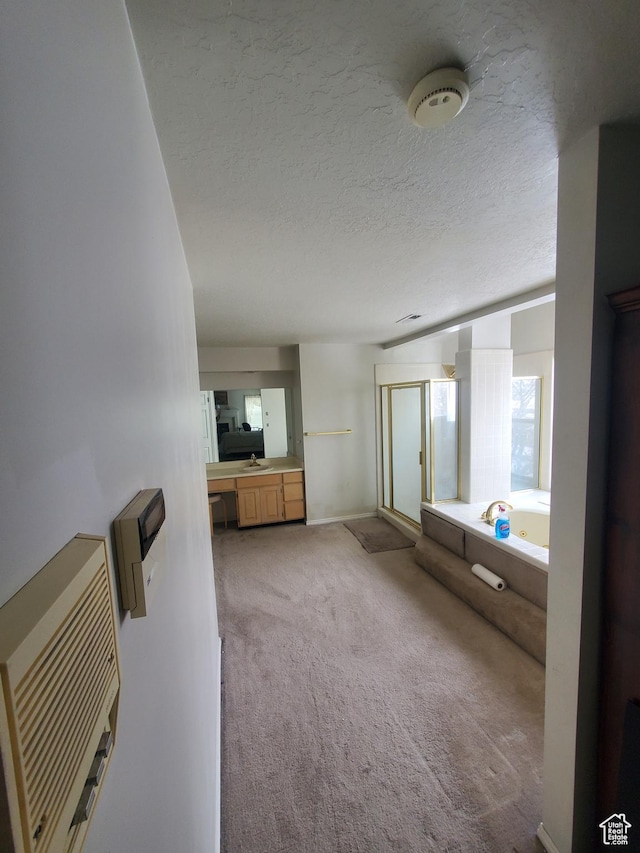 22 Snowstar Ln, Sandy, UT 84092 - bathroom with a garden tub, a stall shower, a textured ceiling, baseboards, and a sink