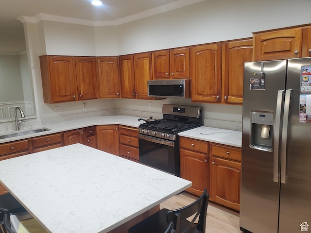 22 Snowstar Ln, Sandy, UT 84092 - kitchen featuring stainless steel appliances, a kitchen bar, a sink, crown molding, and brown cabinets