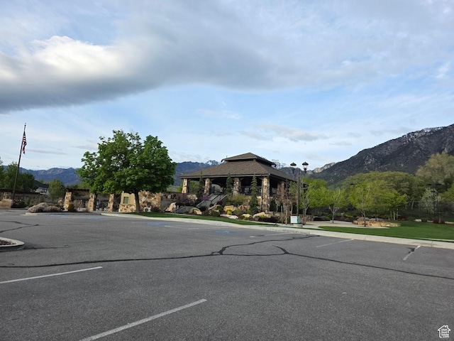 22 Snowstar Ln, Sandy, UT 84092 - view of asphalt street with a mountain view, curbs, and street lights