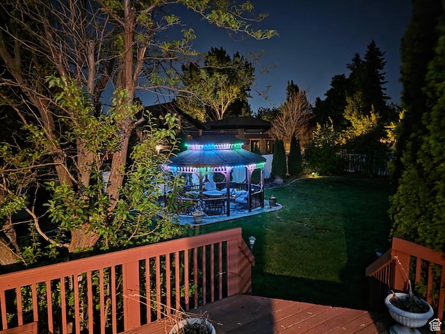 22 Snowstar Ln, Sandy, UT 84092 - deck at night featuring a lawn and a gazebo