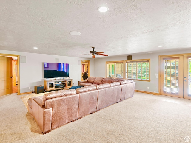 living area featuring light carpet, baseboards, a textured ceiling, a ceiling fan, and recessed lighting