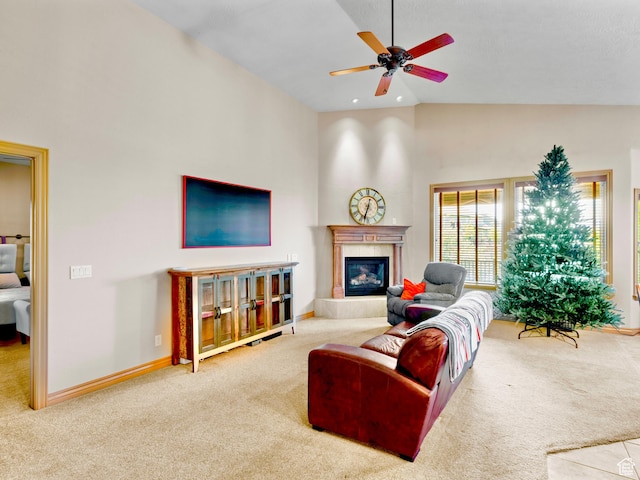 carpeted living room featuring a ceiling fan, a tiled fireplace, high vaulted ceiling, and baseboards