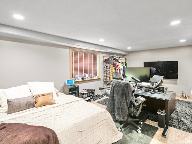 bedroom with recessed lighting and an office area