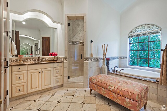 full bath with a stall shower, vanity, a garden tub, and tile patterned floors