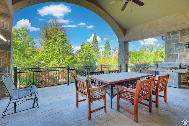 view of patio with area for grilling, ceiling fan, and outdoor dining area
