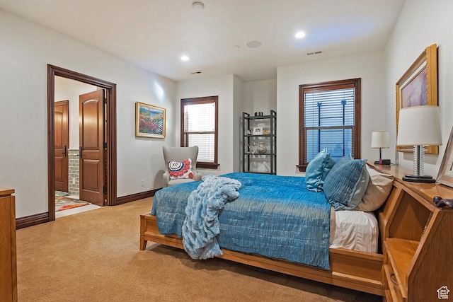 carpeted bedroom featuring baseboards, recessed lighting, and ensuite bath