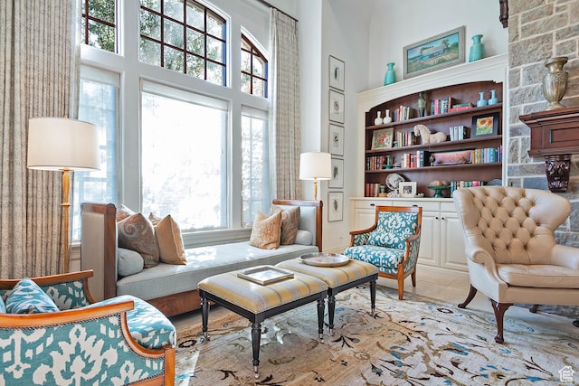 living area featuring a towering ceiling