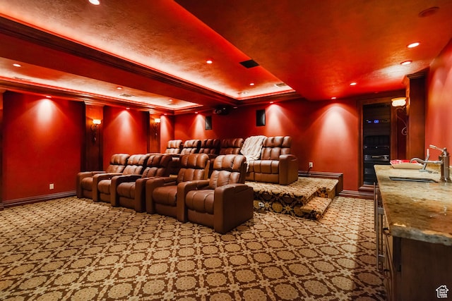 cinema room featuring a sink, carpet flooring, recessed lighting, a raised ceiling, and baseboards