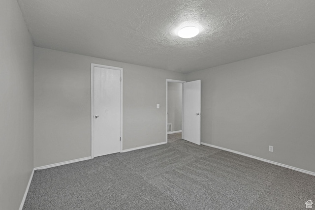 621 W 920 N, Orem, UT 84057 - spare room featuring a textured ceiling, dark colored carpet, and baseboards