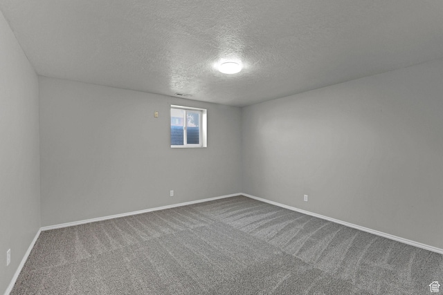 621 W 920 N, Orem, UT 84057 - unfurnished room featuring a textured ceiling, dark colored carpet, and baseboards