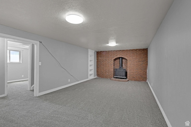 621 W 920 N, Orem, UT 84057 - below grade area featuring a wood stove, a textured ceiling, carpet flooring, baseboards, and brick wall