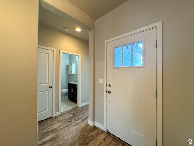 entrance foyer featuring wood finished floors, recessed lighting, and baseboards