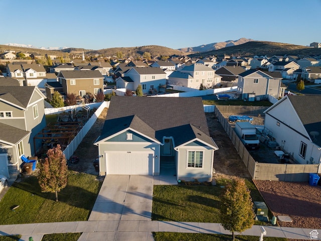 aerial view of residential area featuring mountains