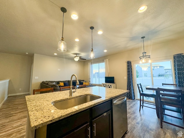 kitchen featuring a sink, dishwasher, dark wood-style flooring, open floor plan, and recessed lighting