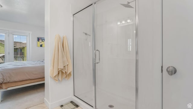 bathroom featuring ensuite bathroom, a stall shower, baseboards, and tile patterned flooring