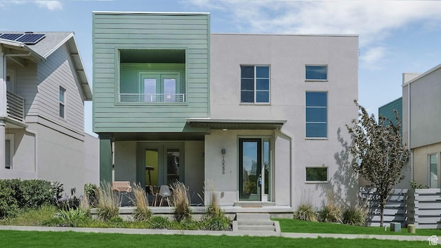 rear view of property featuring stucco siding
