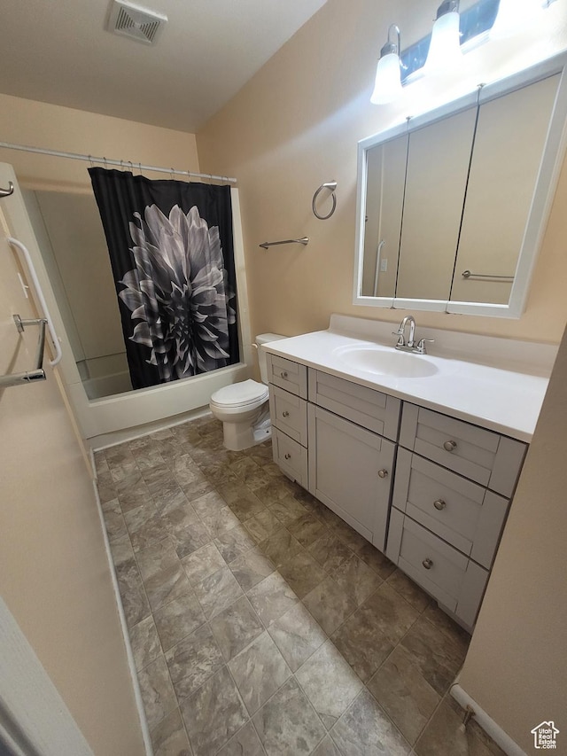 bathroom with toilet, vanity, and shower / bath combo with shower curtain