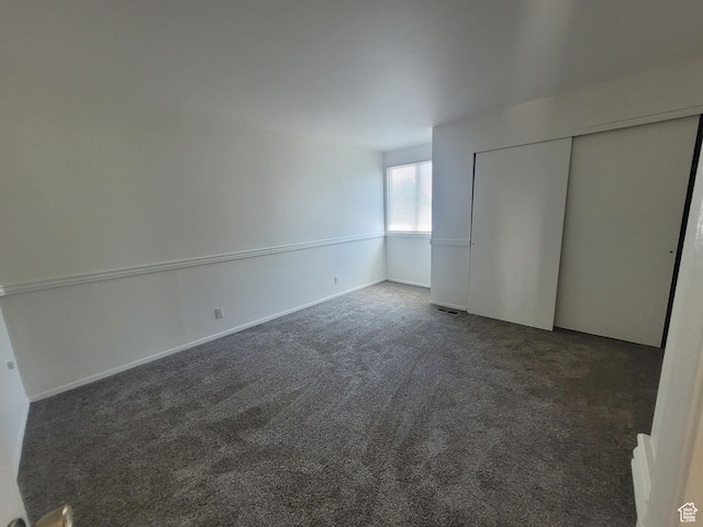 unfurnished bedroom featuring carpet flooring and a closet