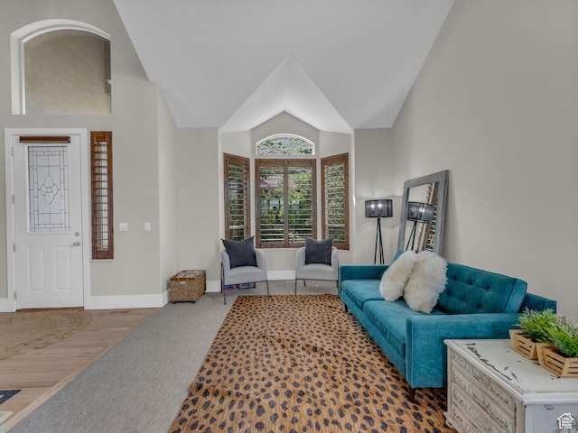 carpeted living room with baseboards and lofted ceiling