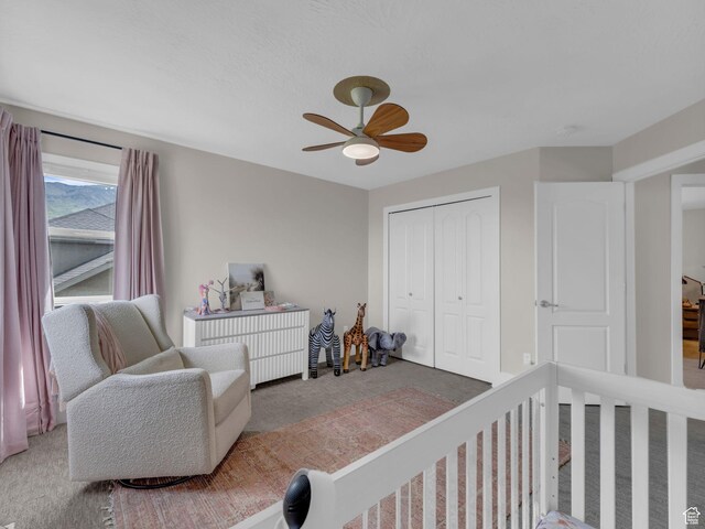 carpeted bedroom with a closet and a ceiling fan