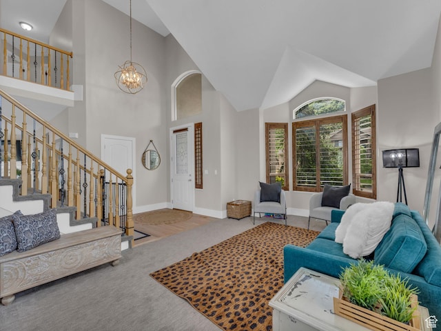 carpeted living room featuring a chandelier, baseboards, stairs, and high vaulted ceiling