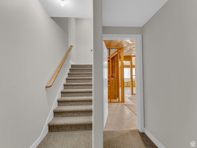 staircase with carpet flooring and baseboards