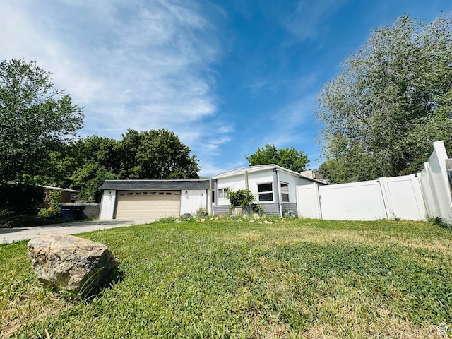 mid-century modern home featuring a garage and driveway