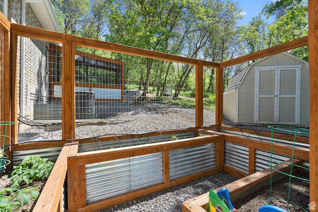 wooden deck featuring a storage unit and an outdoor structure
