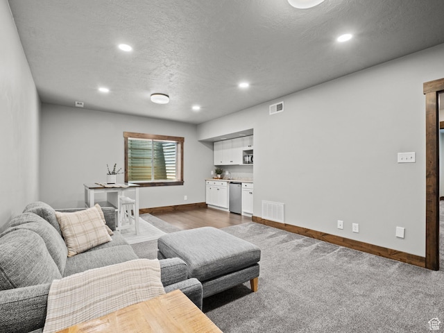 living area featuring baseboards, recessed lighting, a textured ceiling, and dark wood-type flooring