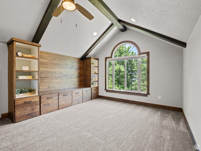 unfurnished living room with carpet, baseboards, ceiling fan, and a textured ceiling