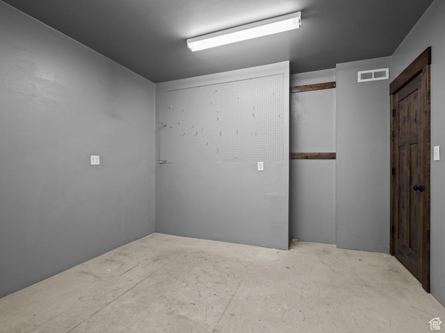 empty room with unfinished concrete floors
