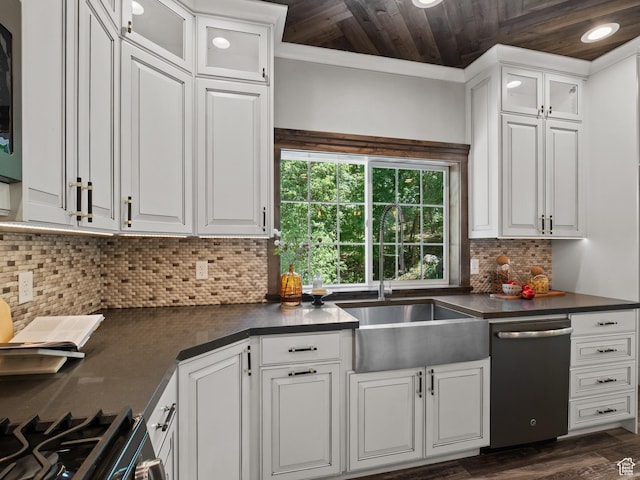 kitchen with stainless steel appliances, dark countertops, a sink, wood ceiling, and white cabinetry