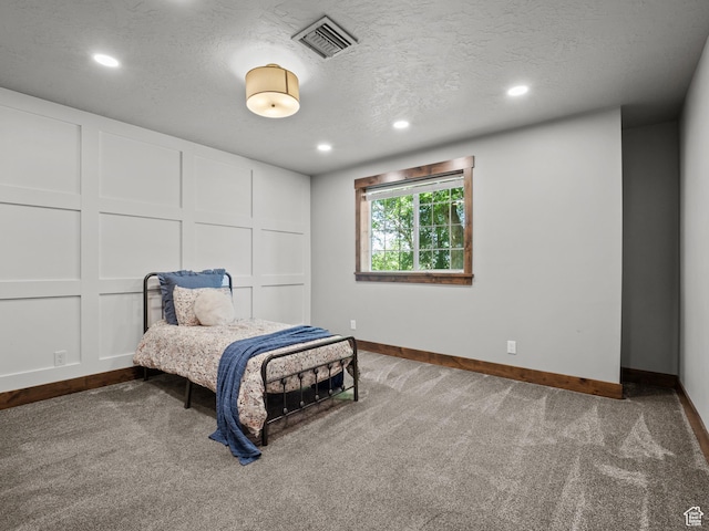 bedroom with baseboards, carpet floors, recessed lighting, and a textured ceiling