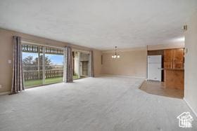 unfurnished living room with carpet flooring and baseboards