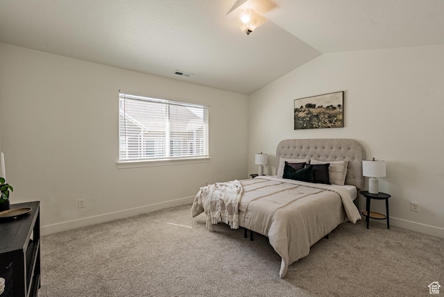 bedroom featuring lofted ceiling, baseboards, and carpet flooring