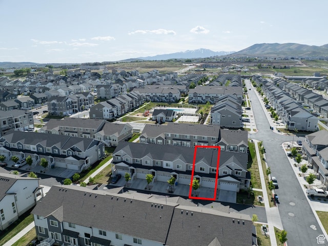 aerial perspective of suburban area with property boundaries highlighted and a mountain backdrop