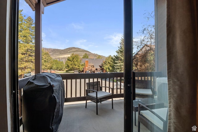 balcony with a mountain view and area for grilling